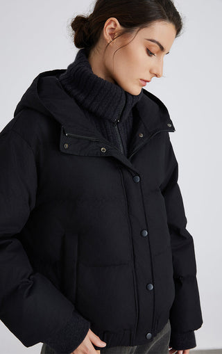 Graphite gray puffer jacket detail: ribbed mock neck, hood, snap placket and zipper