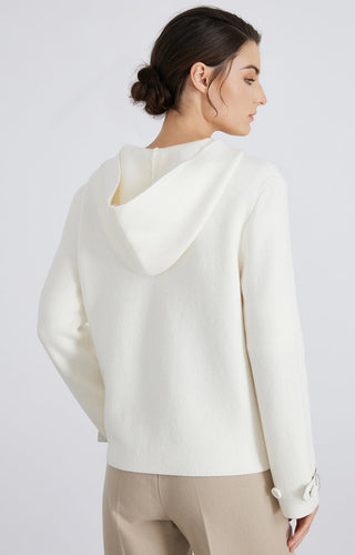 White wool knit hooded jacket, back view; draped hood and full-length zip with pockets.