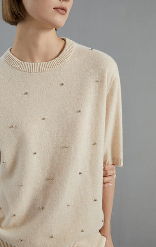 Beige cashmere sweater close-up: crew neckline with embroidered dot details