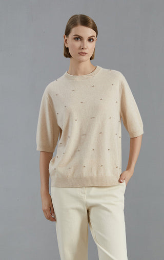Beige cashmere sweater front view with scattered embroidered dot accents and knit hem