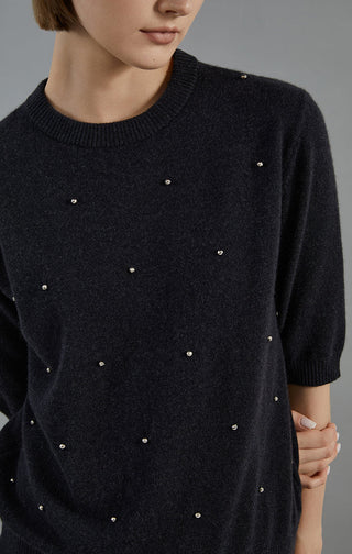 Graphite gray cashmere sweater close-up: embroidered dot details across the torso