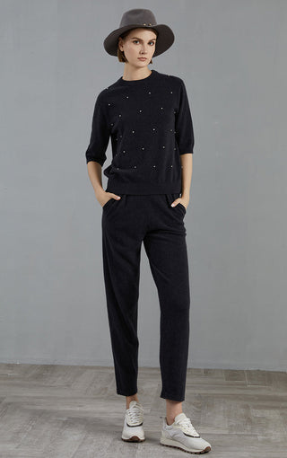 Graphite gray cashmere sweater full front view with embroidered dot accents and cuffed sleeves