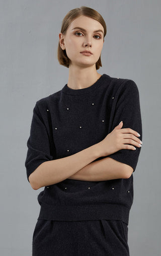 Graphite gray cashmere sweater close-up with embroidered dot accents on knit front