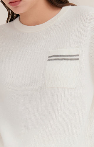 Close-up of cream wool knit sweater chest pocket with dual horizontal stripe detail