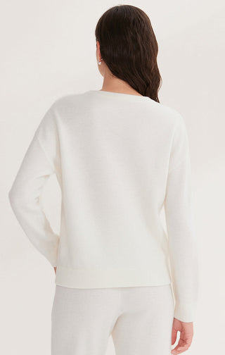 Cream wool knit sweater back view with ribbed hem and long sleeves