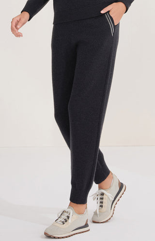 Black wool knit trousers, side view with tapered fit and ankle cuff