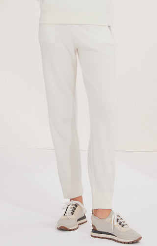 White wool knit trousers, side view with tapered fit and ankle cuff