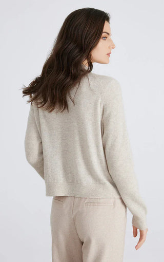 Beige knit cardigan shown from the back with ribbed hem and long sleeves