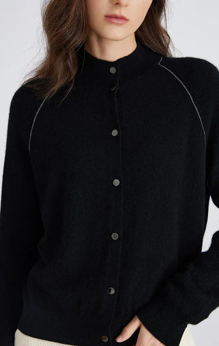Black knit cardigan close-up of round neckline and dark button front