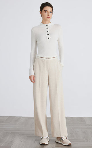 White cashmere-blend mock neck button-up sweater, full outfit view with wide-leg pants
