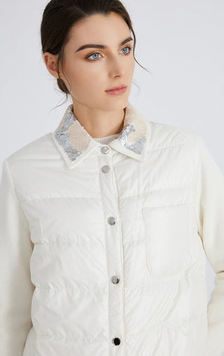 White puffer down jacket close-up: embroidered collar, button placket, quilted body