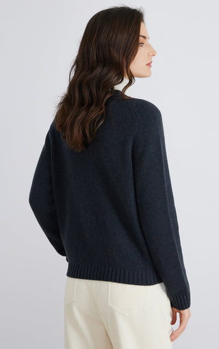 Dark navy wool knit cardigan with ribbed hem and long sleeves, side view.