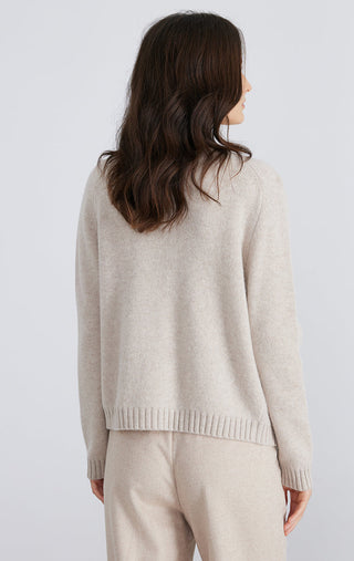 Light beige wool knit cardigan, crew neckline, ribbed hem and long sleeves.
