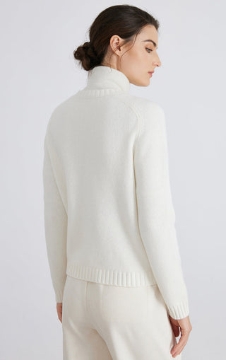 White knit cardigan back view with diamond line pattern and ribbed hem