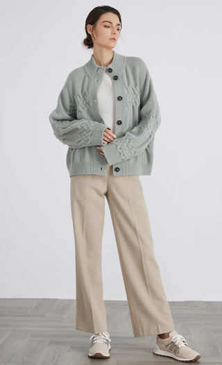 Matcha green button cardigan on model with ribbed hem and cuffs, textured cable sections
