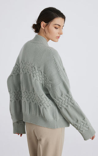 Matcha green cable-knit cardigan, side/back view with ribbed cuffs and textured yoke