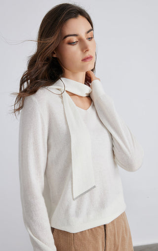 White cashmere pullover with draped tie neckline and long sleeves, textured knit
