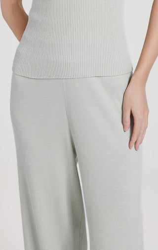 Light gray straight-leg pants with textured weave, side drape and clean waistband