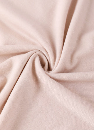 Light apricot wool knit fabric close-up with soft drape and fine texture