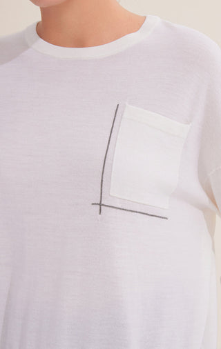 Close-up: white crewneck knit with silver bead line embroidery on chest square