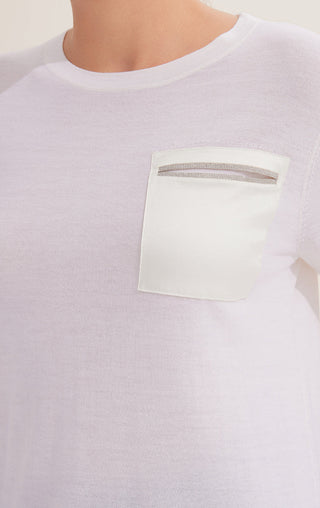 White chest pocket with beaded trim on wool knit top, crew neck