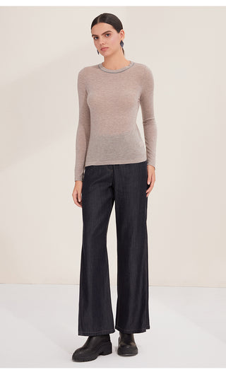 Camel lightweight wool knit sweater worn with dark jeans, crew neck long sleeves