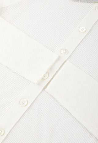 Close-up of white ribbed button front with small round buttons