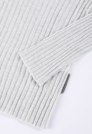 Light apricot ribbed sweater sleeve detail with textured knit and side slit.