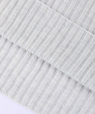 Light apricot ribbed sweater fabric close-up showing fine vertical stripes.