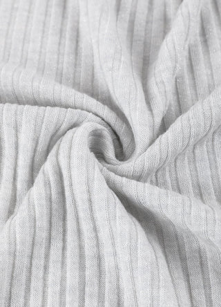 Light apricot wool-blend knit close-up with soft ribbed texture and stretch.