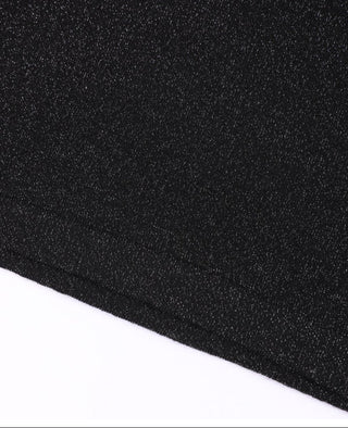 Black speckled knit fabric close-up with fine shimmer specks