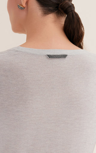 Back of light heather scoop-neck top with small sparkly strap detail at neckline.