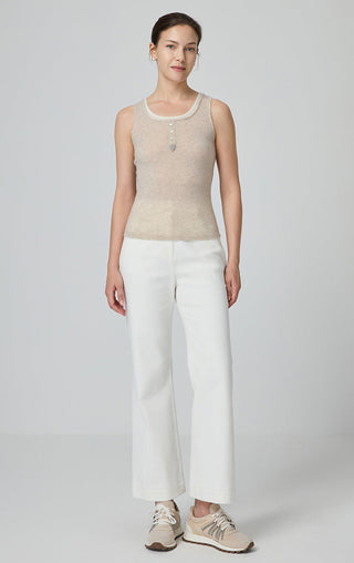 Camel cashmere knit tank and crew neckline with front buttons, paired with white pants