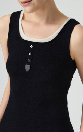 Black cashmere tank neckline close-up with contrast trim and button placket details