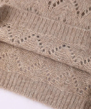 Camel sweater close-up seam area with sparkly sequins on open knit