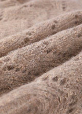 Camel mohair knit close-up with sequins and layered openwork pattern