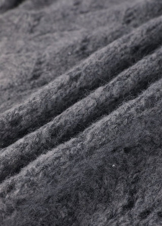 Gray-blue knit stitch detail with sequins along openwork diamond lines