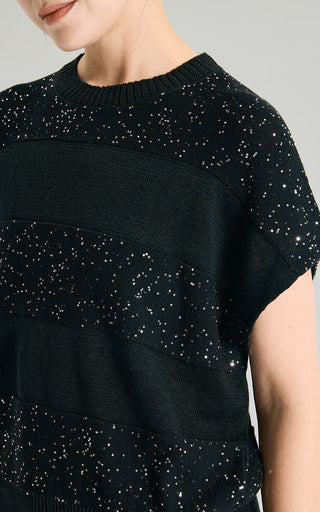 Close-up of black sequin knit sweater with scattered sparkle dots and crew neck