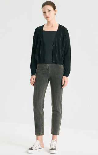 Black v-neck button cardigan on model with cable-knit design and ribbed hem