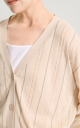 Camel v-neck cardigan detail: cable-knit front with button placket and stitched trim lines