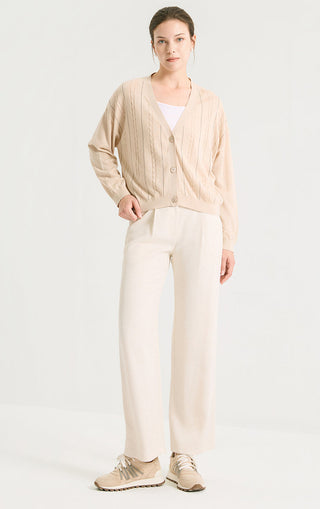 Camel v-neck button cardigan on model with cable-knit texture and ribbed cuffs