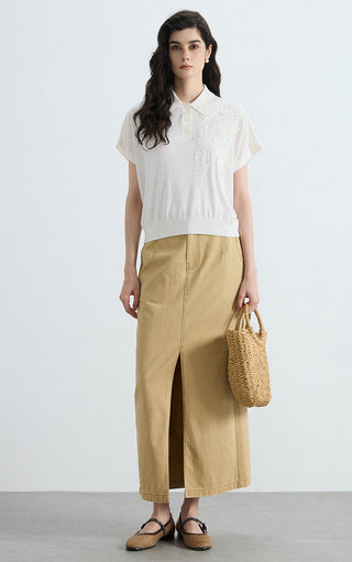 White wool-silk blend polo knit with sequin embellishment at chest, short sleeves