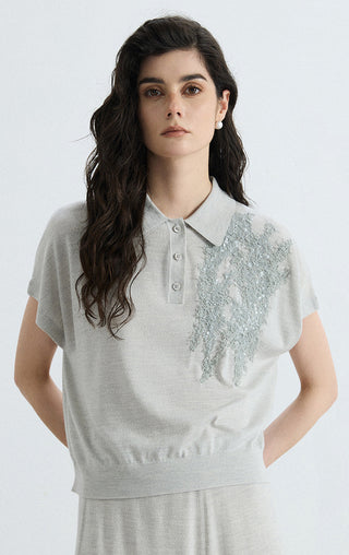 Gray wool-silk polo knit top with short sleeves, button placket, and sequin embellishment
