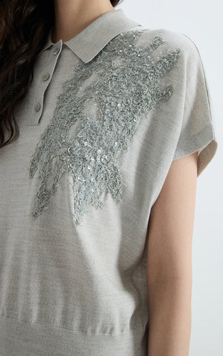 Gray polo knit top close-up: textured sequin panel on the chest