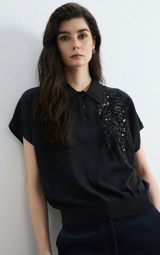 Black wool-silk polo knit top with short sleeves and right-chest sequins over the placket