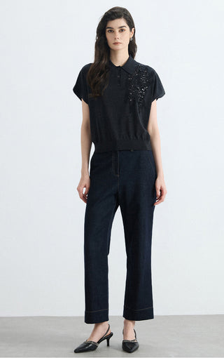 Black polo knit top, short sleeves and right-chest sequin embellishment, front view