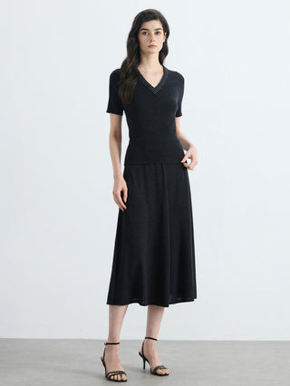 Black slim-fit V-neck ribbed knit top with short sleeves and layered hem detail