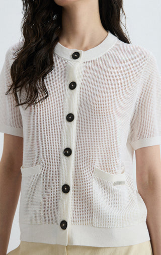 Ivory white sheer knit cardigan close-up: dark buttons, crew neck, patch pockets