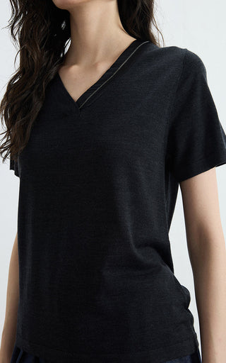 Black v-neck knit tee close-up, V-neck seam and short sleeves