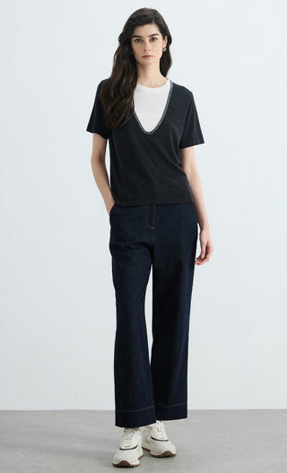 Black layered knit tee front view, contrast V-neck trim over white crew neckline